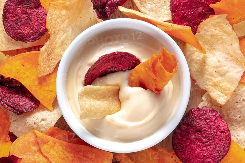 Vegetable chips with a dip close-up shot, top view