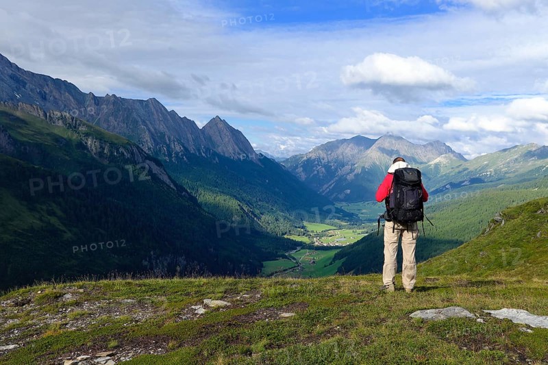 Hiker looking from the Pfitscherjoch into the Pfitschtal, Pfitsch, South Tyrol, Italy, Europe
