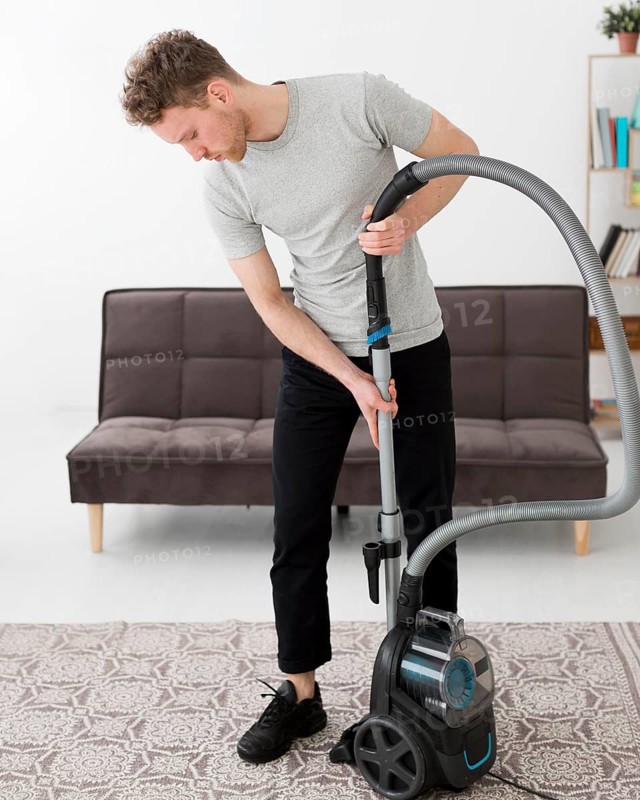 Male with vacuum cleaning