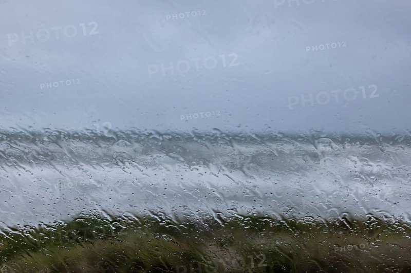 View of the stormy sea through raindrops on a window pane, Portbail, Cotentin, Manche, Normandy, France, Europe