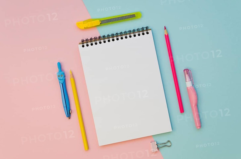 Top view notebook with colorful pens