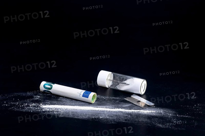 Cocaine Line and Razor Blade on a Black Background