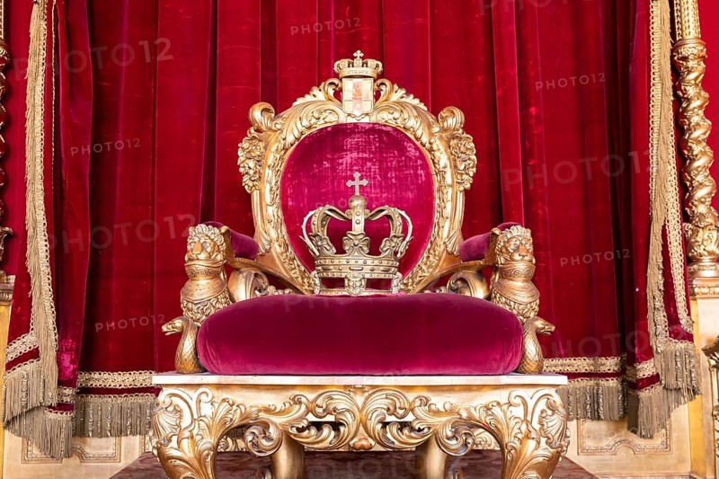 Genoa, Italy, 06 August 2023: Royal Palace, throne room interior, gold and red velvet, Europe