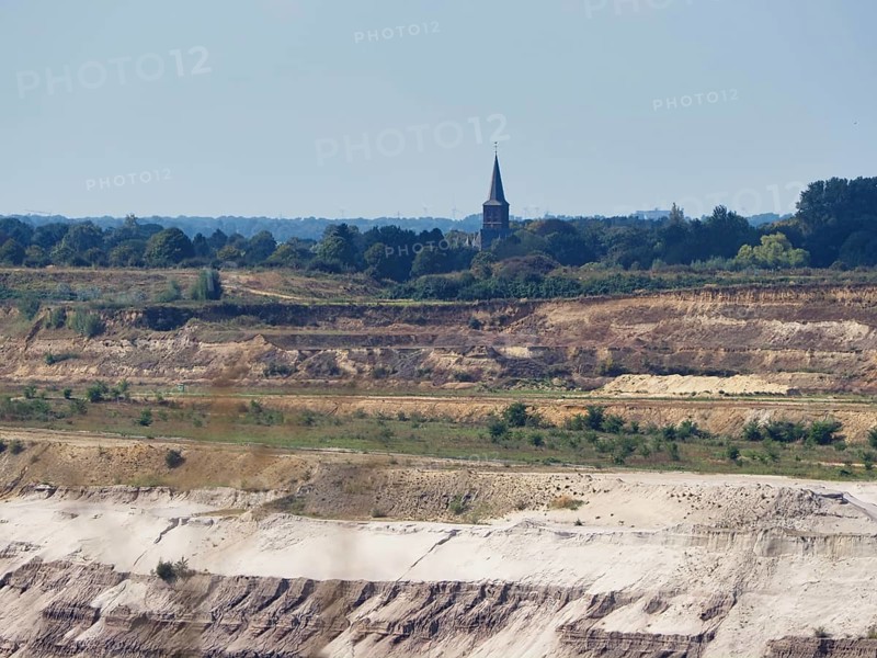 A church tower right on the edge of the Garzweiler open-cast lignite mine, Rhenish lignite mining area, Germany, Europe