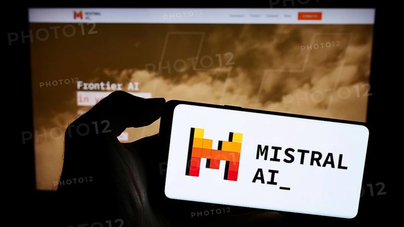 Stuttgart, Germany, 11-27-2023: Person holding mobile phone with logo of French artificial intelligence company Mistral AI SAS in front of web page. Focus on phone display, Europe