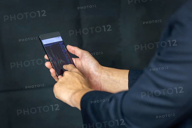 Stock Trader Looking At Stock Chart on Screen