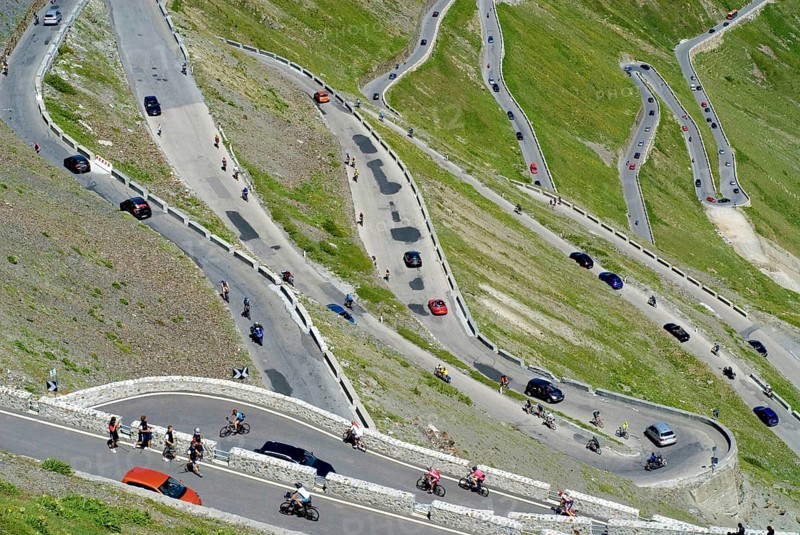Stelvio Pass with hairpin turns, much traffic in the summer season, busy and crowded with pedestrians, bikers, cars, traffic jam, South Tyrole, Alps, Italy, Europe, the picture is Digital compositing, Europe