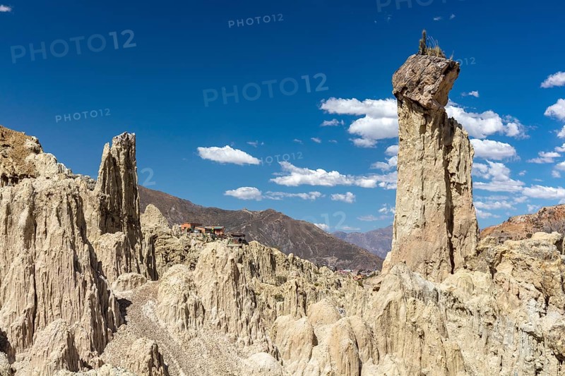 Earth pyramids with rocks on top, called Demoiselles Coiffées, precariously balanced rocks in Valle de la Luna, Moon Valley formed by erosion, also Killa Qhichwa, La Paz, Bolivia, South America