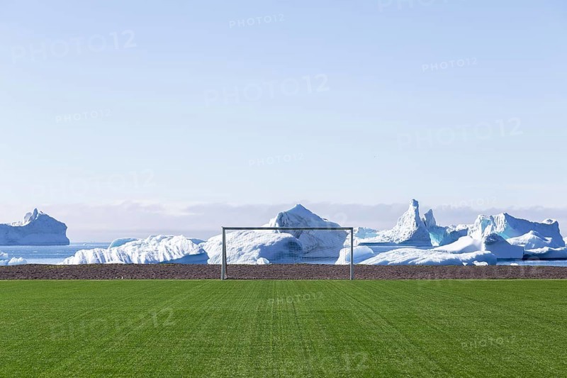 Qeqertarsuaq, Greenland, July 6, 2018: The soccer field with icebergs in the background, North America