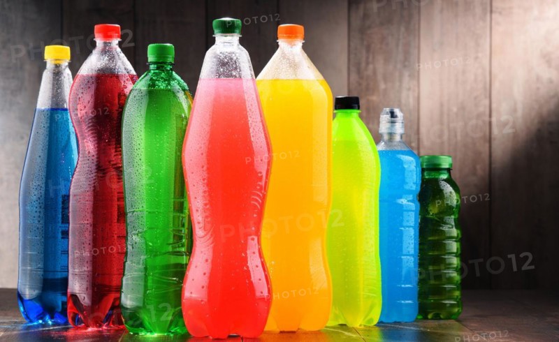 Plastic bottles of assorted carbonated soft drinks in variety of colors