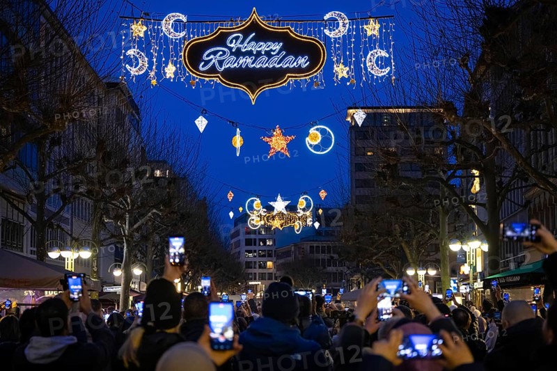 The illuminated lettering Happy Ramadan shines on the evening of 10 March 2024 as part of a light installation stretched across Große Bockenheimer Straße (Fressgass) in Frankfurt am Main. Ramadan is the month of fasting for Muslims and the ninth month of the Islamic lunar calendar. According to Islamic belief, the Koran was revealed during this month. In 2024, Ramadan begins on the evening of 10 March and ends on the evening of 9 April, Große Bockenheimer Straße, Frankfurt am Main, Hesse, Germany, Europe