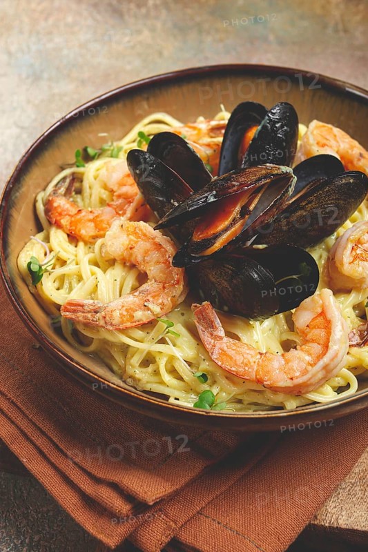 Spaghetti carbonara, with shrimp and mussels, seafood in creamy garlic sauce, homemade, no people