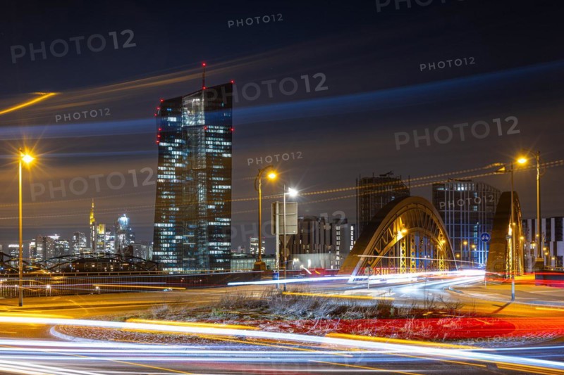 The lights of the European Central Bank (ECB) and the Frankfurt banking skyline glow in the evening, Osthafen, Frankfurt am Main, Hesse, Germany, Europe
