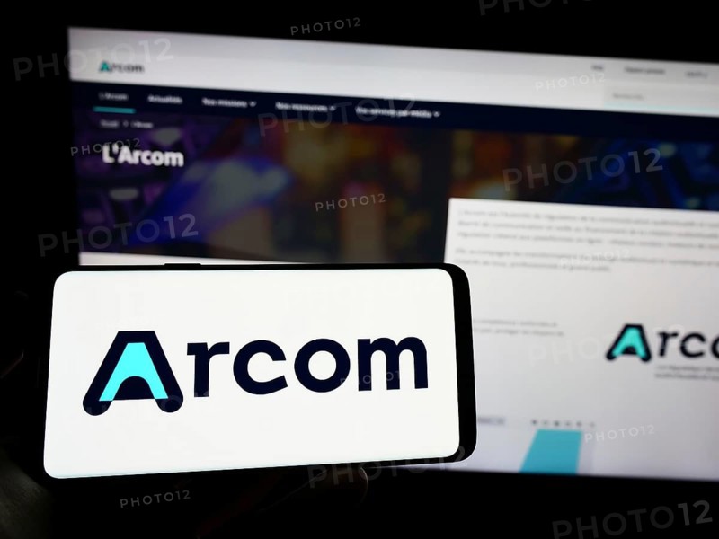 Stuttgart, Germany, 12-02-2022: Person holding mobile phone with logo of French digital regulation agency ARCOM on screen in front of web page. Focus on phone display, Europe
