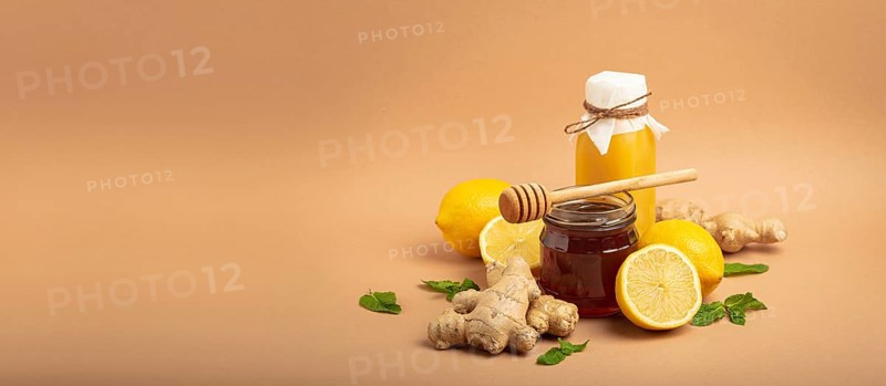 Composition with detox drink, sea buckthorn berries, lemons, mint, ginger, honey in glass jar. Food for immunity stimulation and against flu. Healthy natural remedies to boost immune system, food photography, food photography