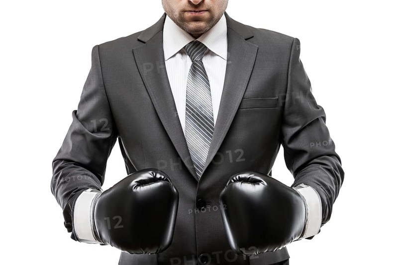 Business career and professional competition success concept, businessman boxer in black suit wearing sport boxing gloves white isolated