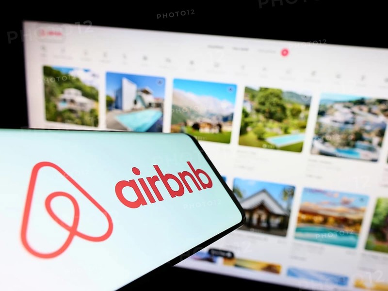 Stuttgart, Germany, 11-30-2022: Smartphone with logo of American homestay marketplace company Airbnb Inc. on screen in front of business website. Focus on right of phone display, Europe