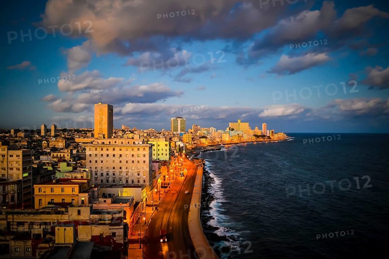 High angle view on Havana malecon coastal road and cityscape during sunset. Travel and tourism