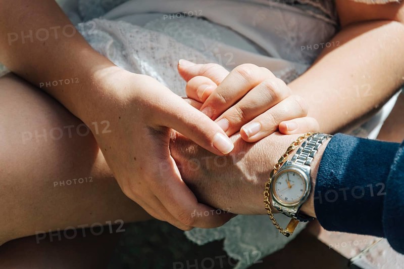 Hands of mother and daughter holding together showing love and gratefulness