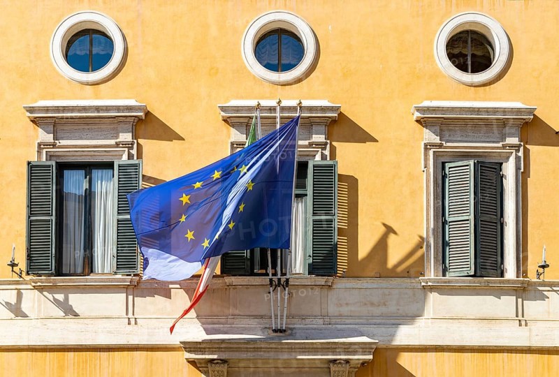 A picture of the Italian and European Union flags on a building facade