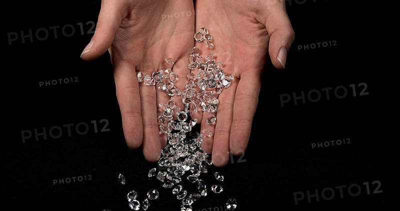 Hand of Woman with Diamonds against Black Background