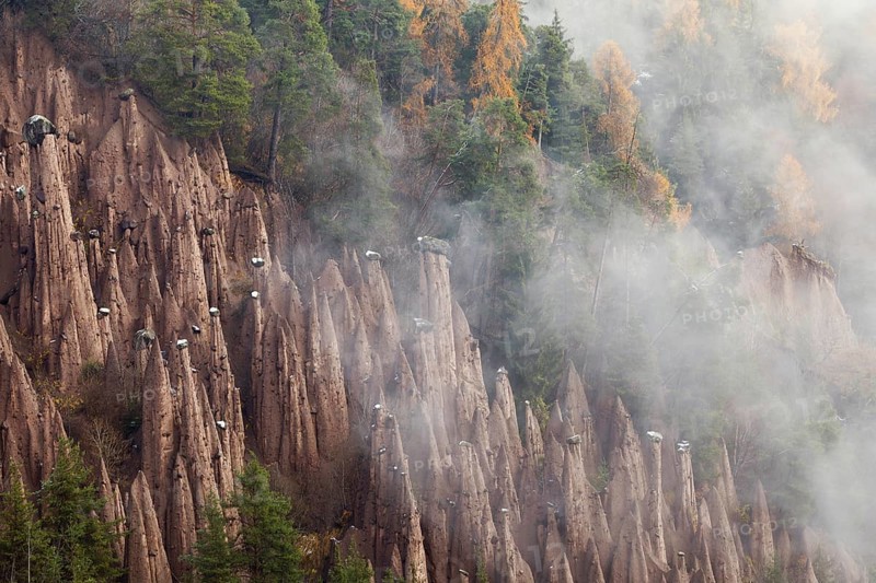 Rittner Erdpyramiden fairy chimneys of Lengmoos in rising mist, Bolzano, South Tyrol, Italy, Europe