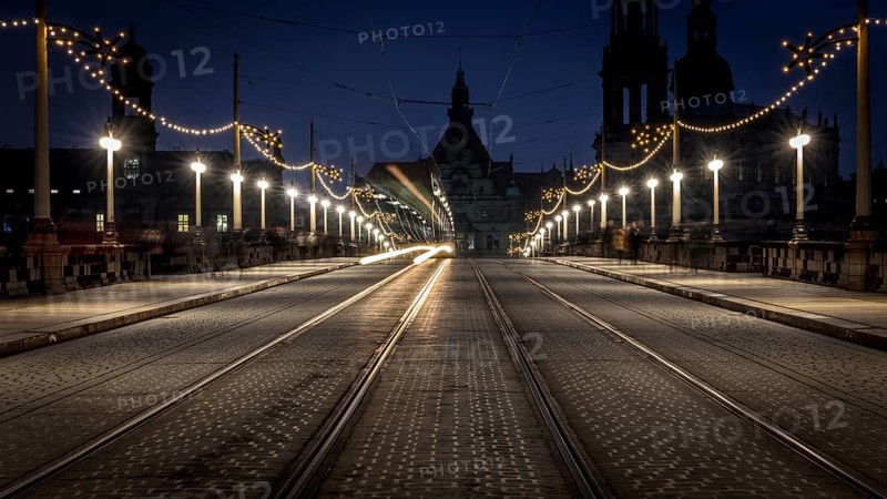 Dark, evening street view with light traces of a tram and illuminated architecture in the background, Christmas market Augustusbrücke Dresden