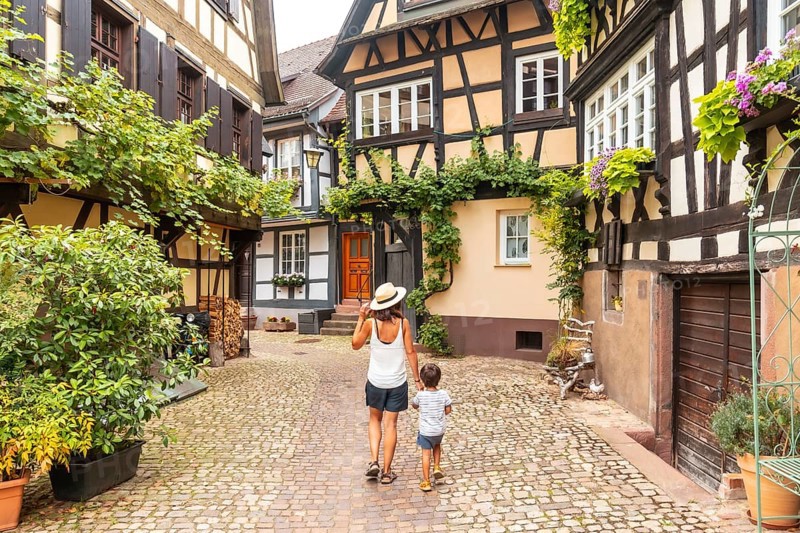 Mother and son in the medieval village in the old town of Gengenbach in the Black Forest, Germany, family vacation concept, Europe