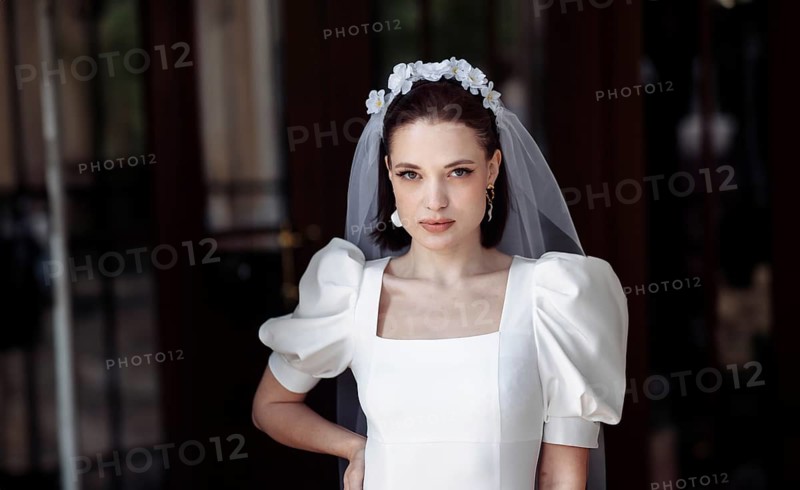 Beautiful young woman bride happy on her wedding day in a white dress and veil