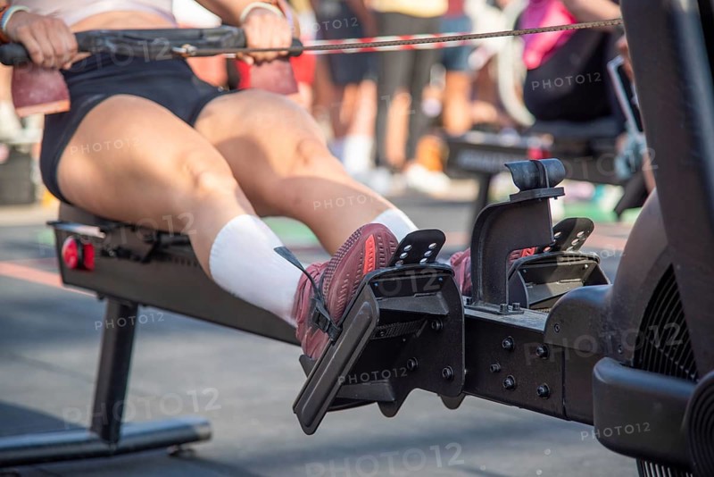 Close-up of a person using a rowing machine in the outdoor gym, focusing on his legs, Barcelona, Spain, Europe