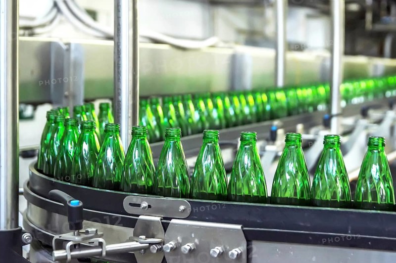 Closeup on mineral water green bottles in raw and lines
