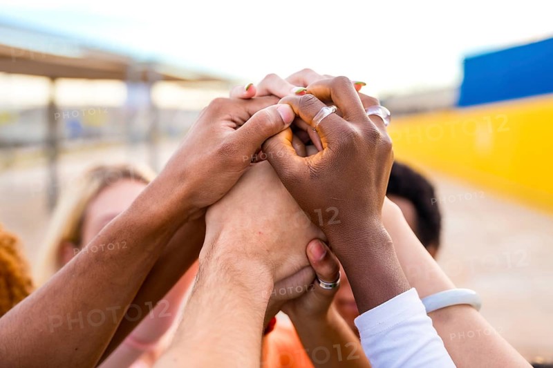 Close-up of hands of multi-ethnic people joining in the air