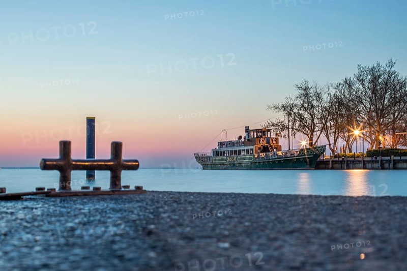 Sunrise on the shore and harbour of a lake in summer. Colourful sky with a wide view of the horiont. Natural landscape at Tihany marina, Lake Balaton, Lake Balaton, Siófok, Hungary, Europe