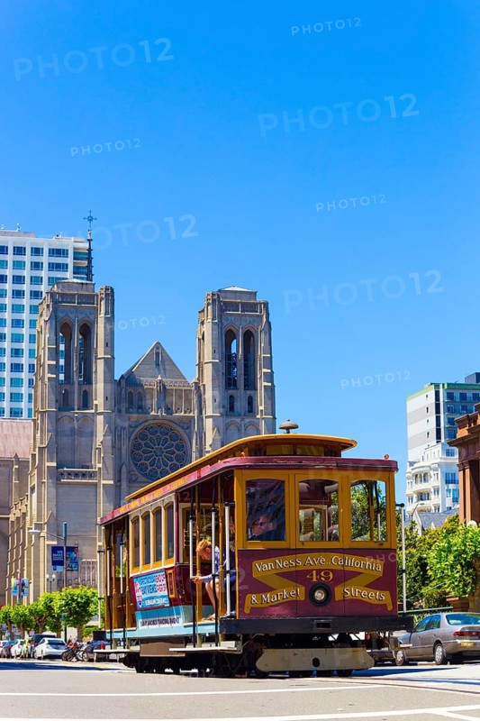 San Francisco, USA, May 20, 2016: Cable car passing down California Street in front of Grace Cathedral on top of Nob Hill. Vertical, North America