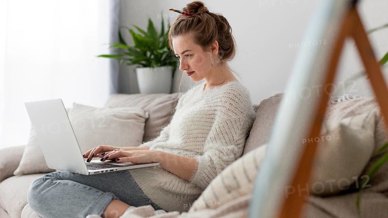 Side view woman writing blog home