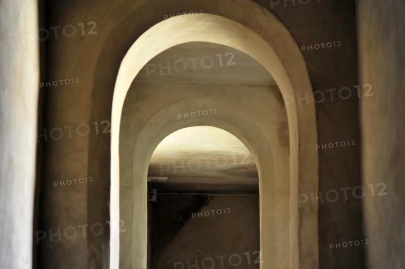 Seville, A series of repeating white arches in a tunnel create a deep perspective, Seville, Andalusia, Southern Spain, Spain, Europe