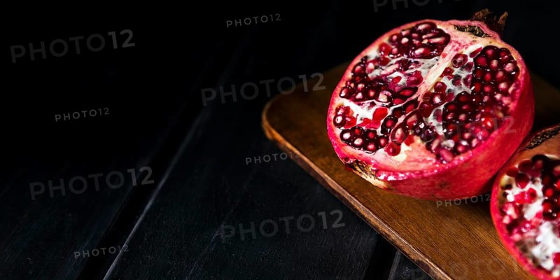 High angle autumn pomegranate halves with copy space