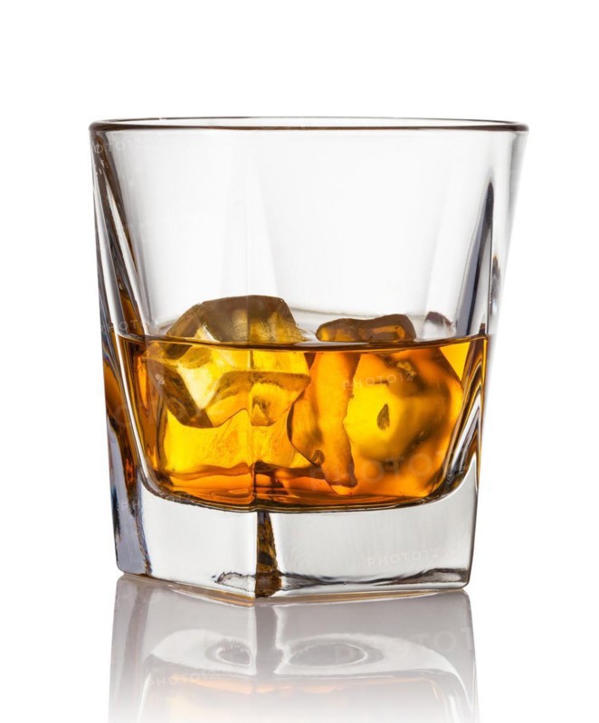 Glass of scotch whiskey and ice on a white background