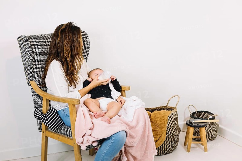 Mother feeding baby nursery