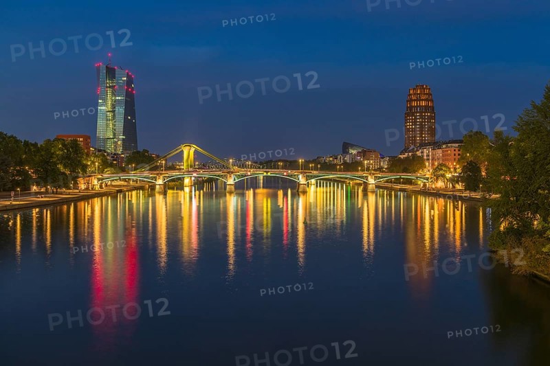 View at blue hour of the colourfully illuminated Flößerbrücke, the European Central Bank on the left and the Main Plaza on the right, Frankfurt am Main, Hesse, Germany, Europe