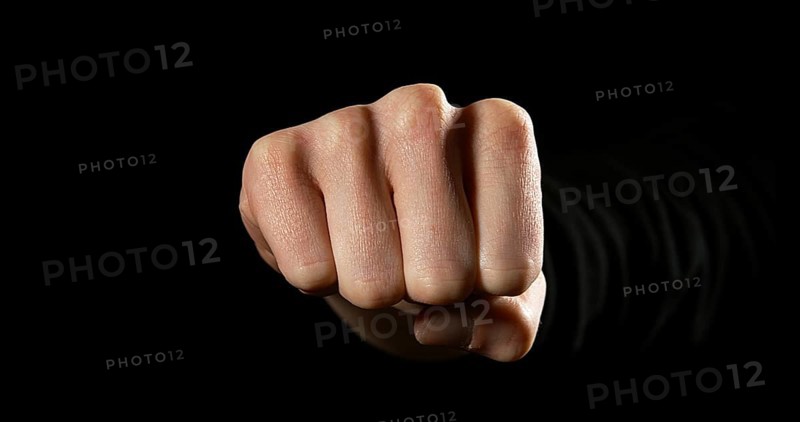 Woman's Fist against Black Background