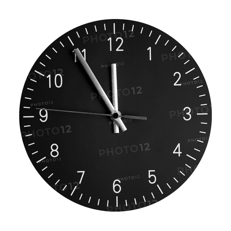 isolated wall clock with its hands at 5 to 12. concept for high time or 5 minutes to midnight