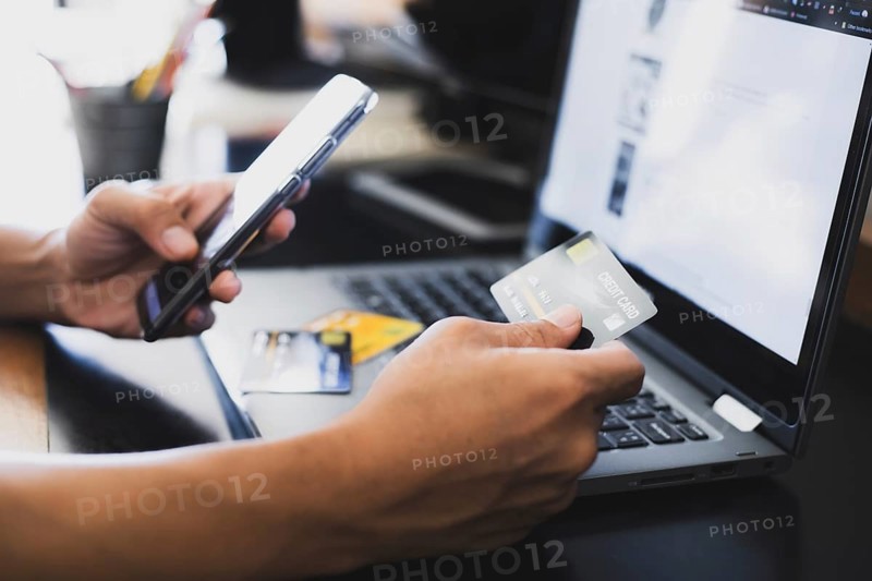 A man online shopping at home using credit card, Mobile phone and laptop for online shopping, technology and internet concept
