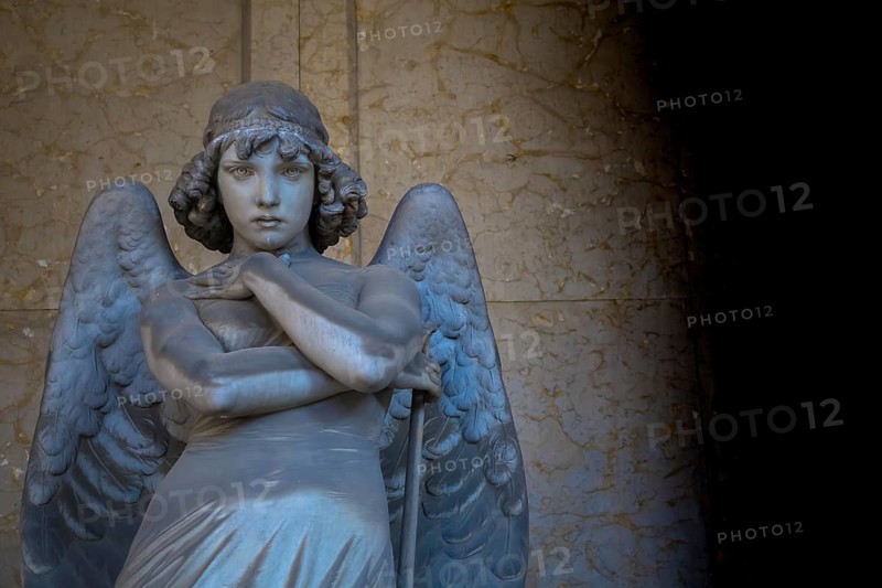 GENOA, ITALY - June 2020: antique statue of angel (beginning 1900) (marble) in a Christian Catholic cemetery - Italy
