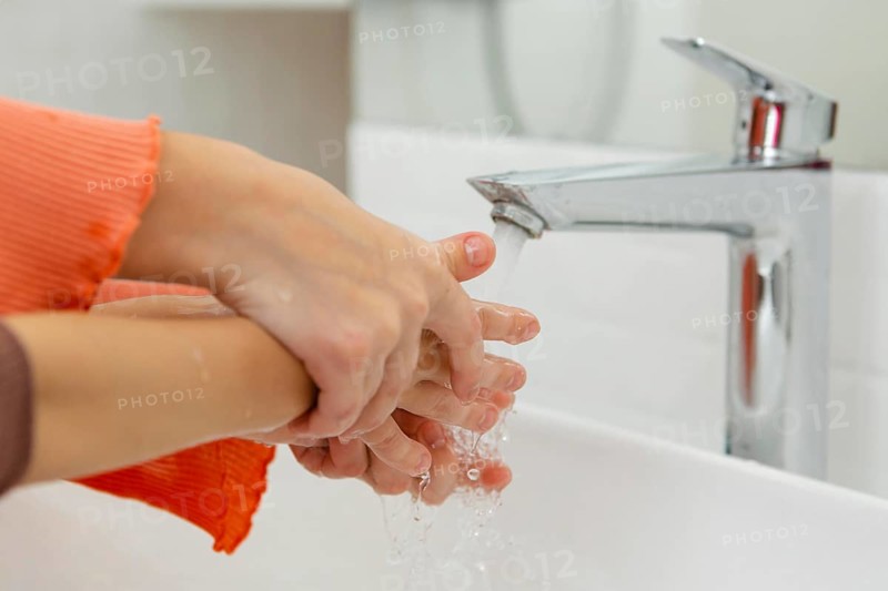 Little kids washing their hands close up