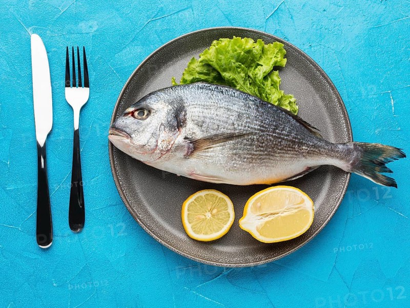 Top view fish with lemon plate