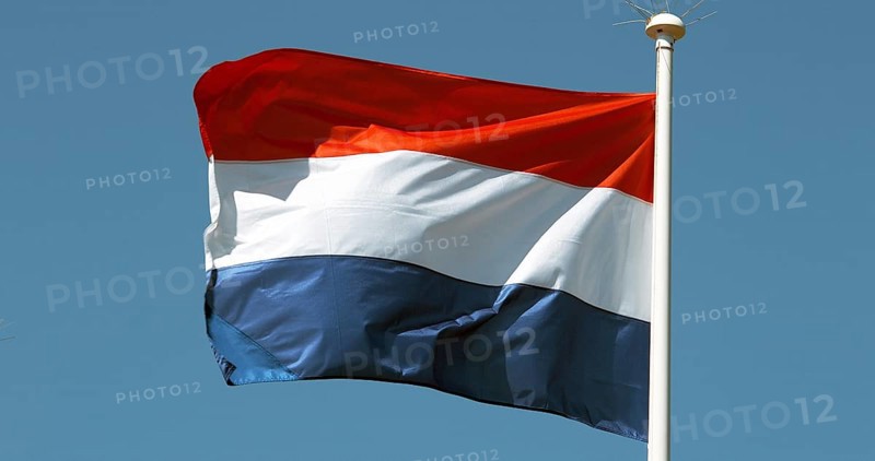 Netherlands Flag Waving in the Wind against blue sky