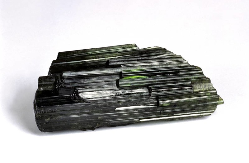 Green tourmaline stone against white background