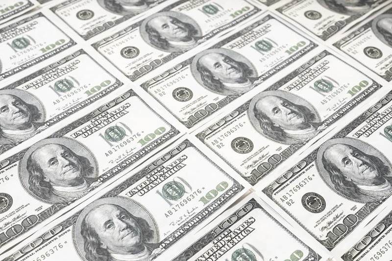 US dollar background. Closeup of a rows of banknotes hundred dollar bills. American currency
