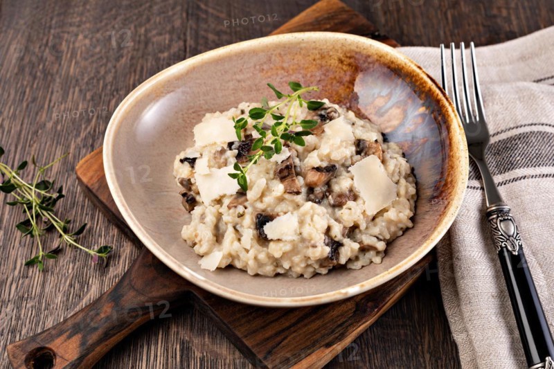 Risotto with porcini mushroom on wooden table